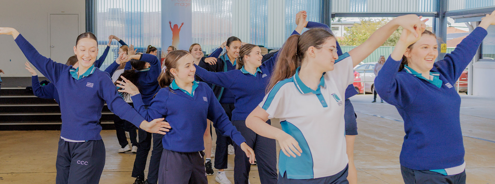 Caroline Chisholm Catholic College Glenmore Park students dancing in sports uniform